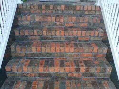 Completed brick staircase with clean mortar lines and contrasting red and dark bricks