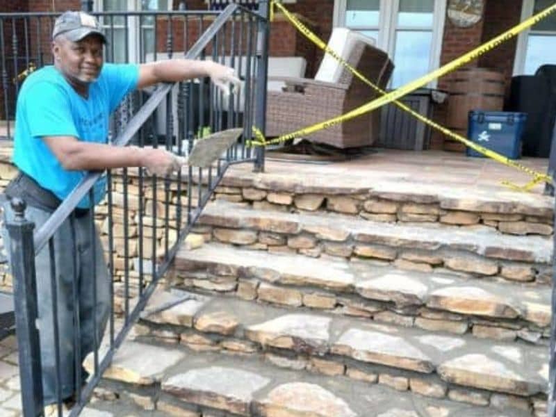Masonry contractor repairing stone stairs and patio in Alabama
