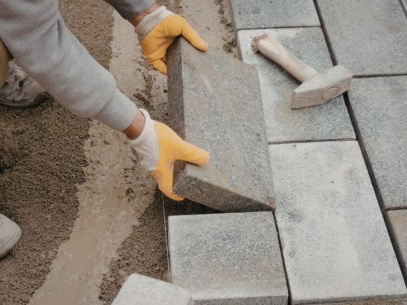 Close-up view of a brick paver herringbone pattern creating a timeless and durable outdoor surface