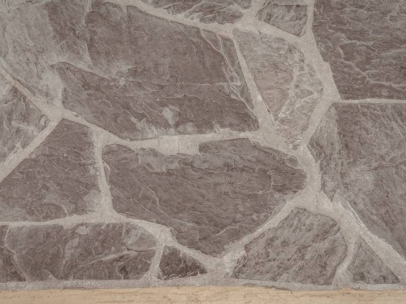 Natural stone patio with irregular flagstone pattern and light grout joints