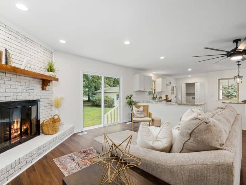 Brick fireplace surround designed beside corner windows with balanced brickwork, window clearance, and finished wall transitions.